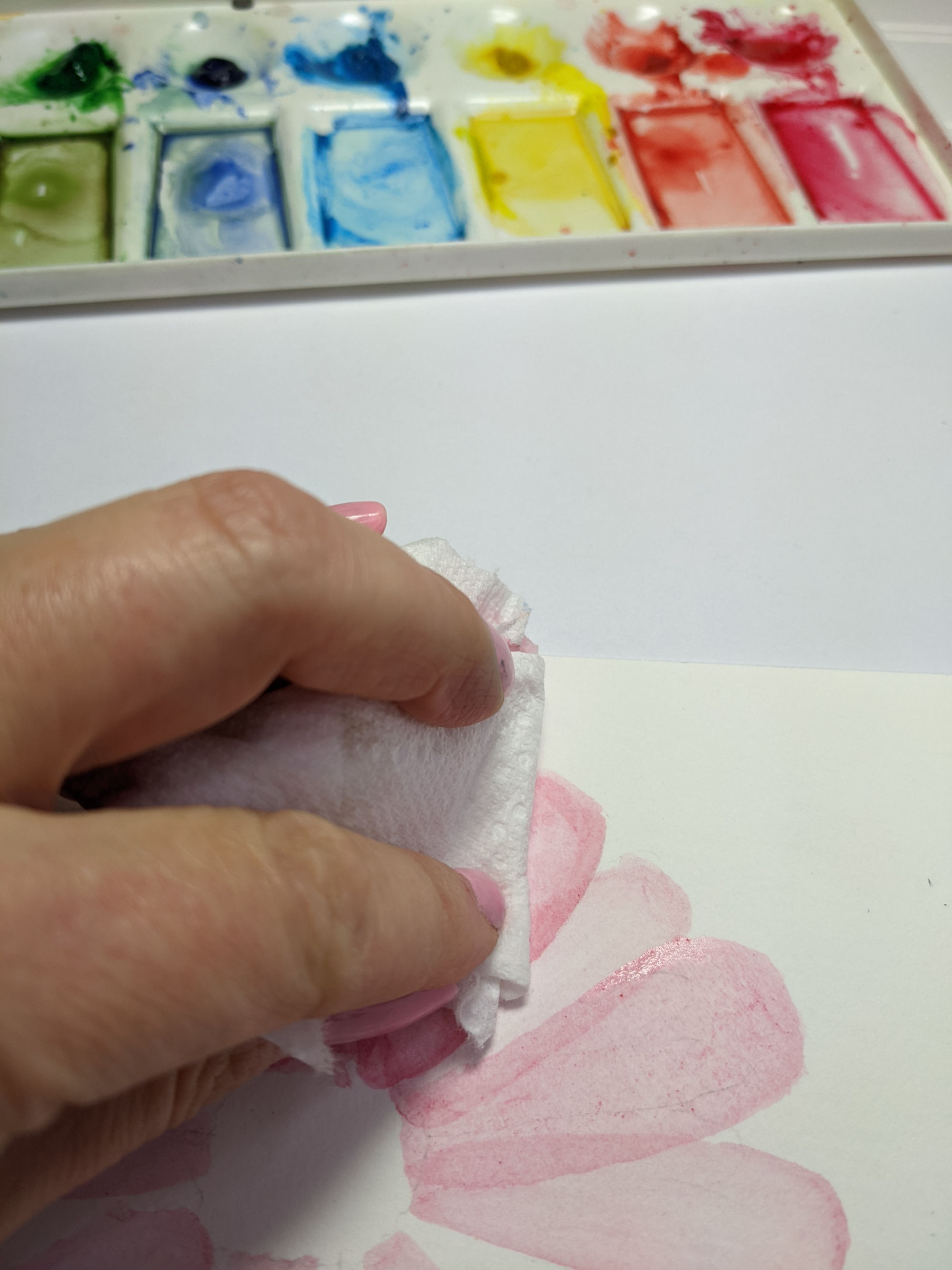 blotting the extra pink watercolor on abstract flower tutorial